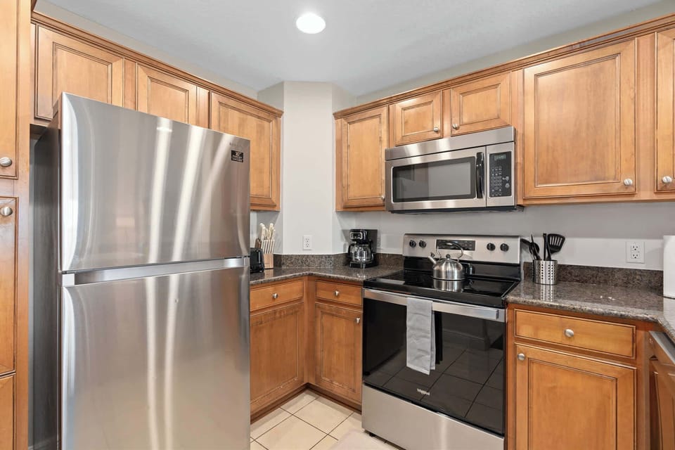 Fully equipped kitchen with stainless appliances and ample counter space.