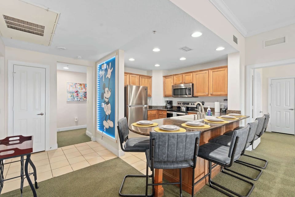 Kitchen and dining area with breakfast bar seating for five.