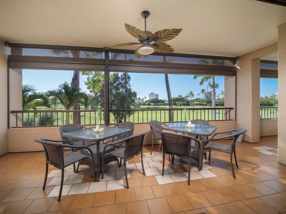 Relax on the large lanai with a cooling ceiling fan, ideal for outdoor dining while enjoying picturesque golf course views.