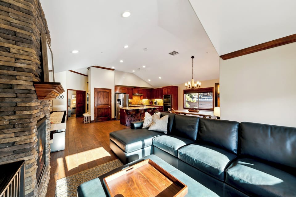 Sink into plush leather seating by your stone fireplace, with the gourmet kitchen and dining area creating the perfect open-concept retreat.