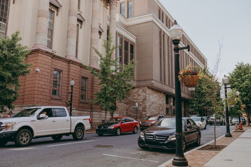Neighboring building, with parked vehicles on the street