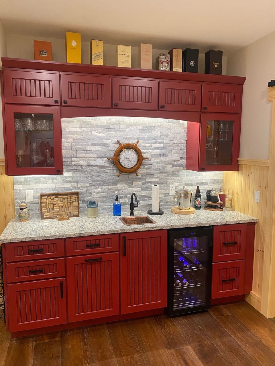 Wet bar in lower level feature beverage cooler, sink, glassware & accessories.