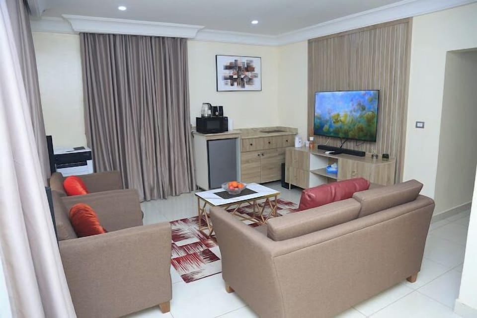 Deluxe Room, Balcony, City View | Living area | TV