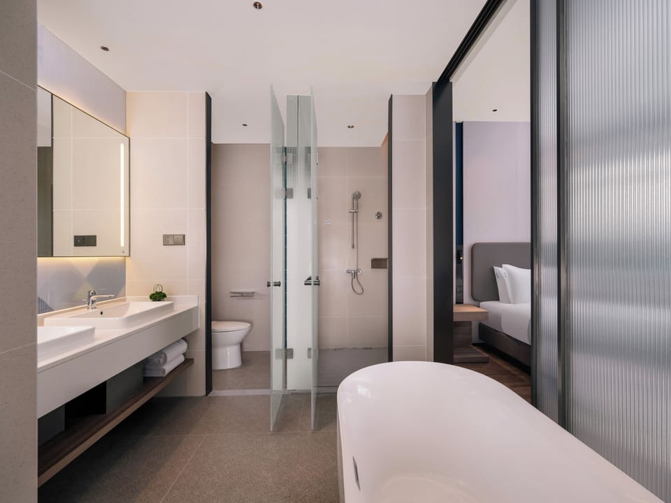 Suite, 1 King Bed, Bathtub | Bathroom | Free toiletries, hair dryer, slippers, towels