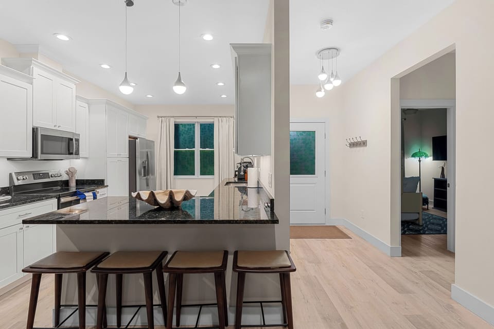 Modern kitchen with a spacious island and sleek appliances, perfect for cooking!