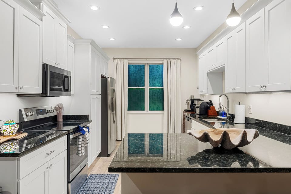 Stylish kitchen with a large island and modern lighting, ideal for a serene stay! 🌞✨