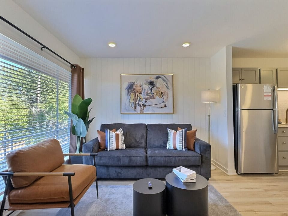 An elegant living area in Downtown Birmingham that blends modern design, natural light, and cozy touches for the perfect stay.