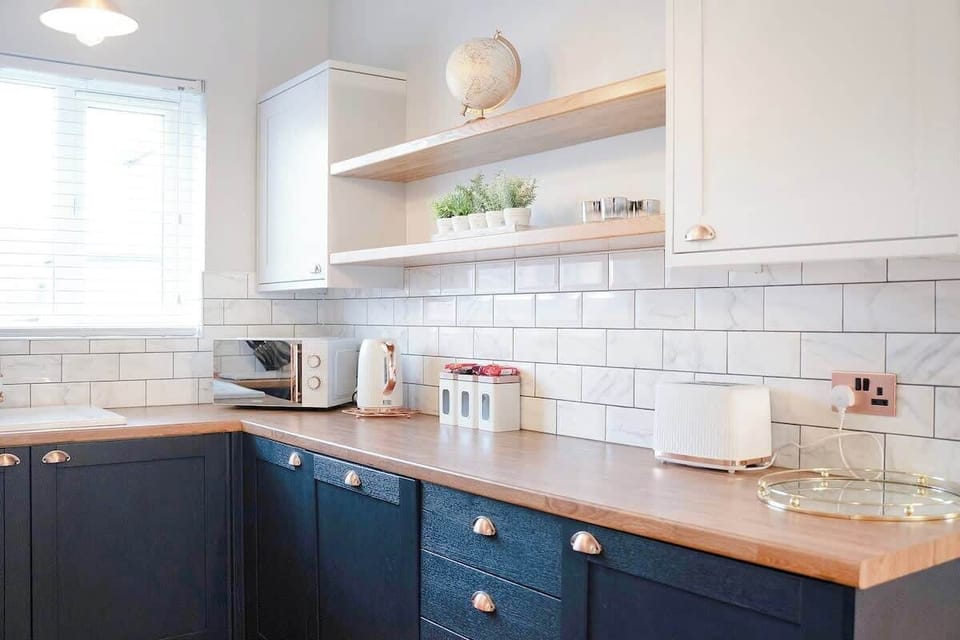 Kitchen equipped with all essentials, including a washer & dryer, oven, fridge and full cookware set.