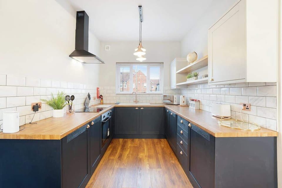 Kitchen equipped with all essentials, including a washer & dryer, oven, fridge and full cookware set.