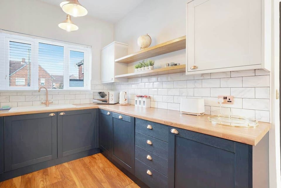 Kitchen equipped with all essentials, including a washer & dryer, oven, fridge and full cookware set.