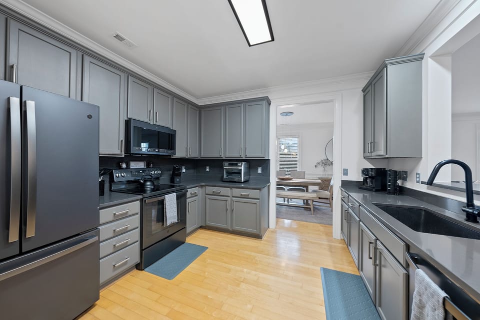 Fully equipped kitchen with Keurig coffee maker and toaster oven/air fryer.