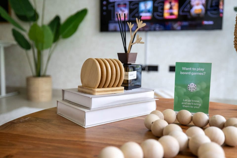 Tabletop decor with coasters, diffuser, and a board games sign on the coffee table