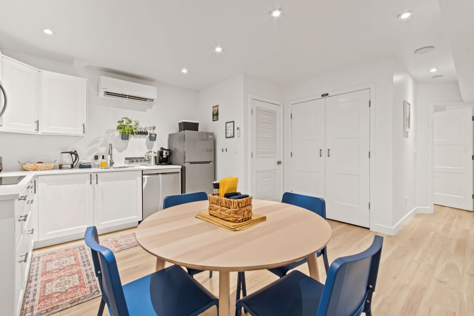 Bright modern kitchen with cozy dining space and stylish blue seating