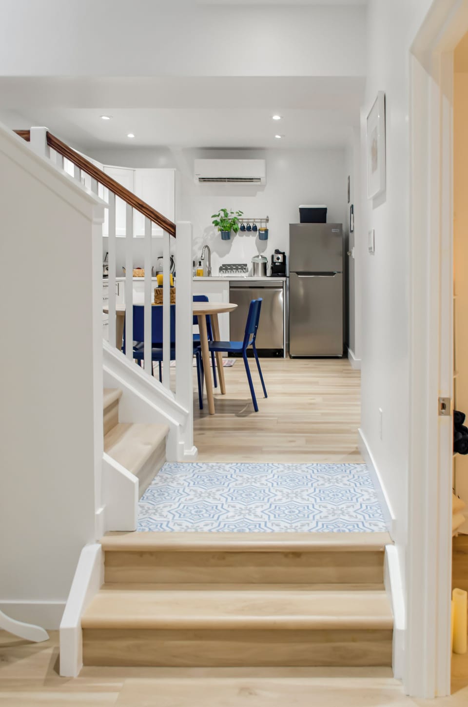 Bright modern kitchen with dining nook, AC, and stylish finishes