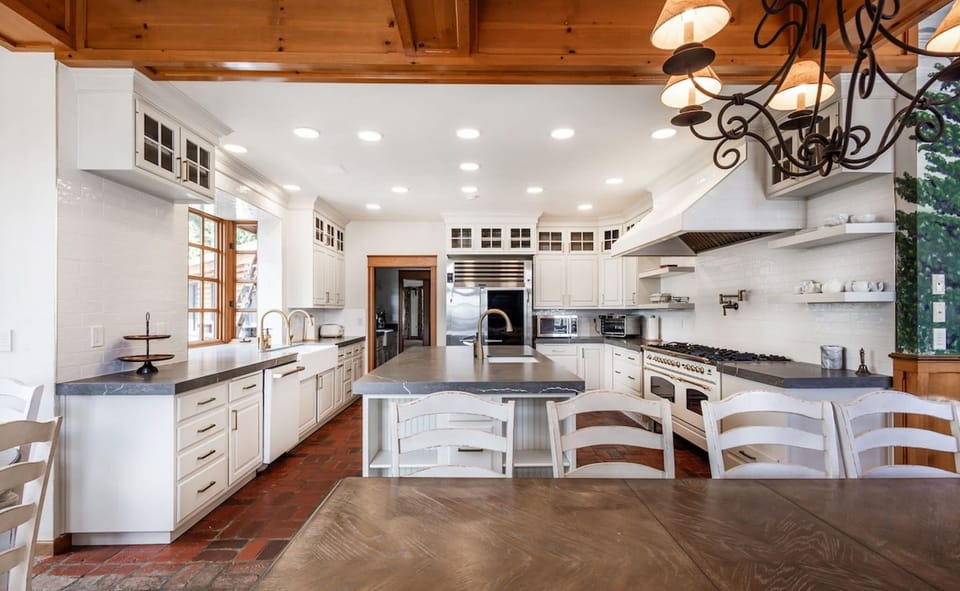 With a luxury 10-burner stove, large quartz island, and ample cookware, the main kitchen makes group dining a pleasure. Nearby, the dining area seats 35, with wraparound windows showcasing breathtaking views of the San Juan Islands.