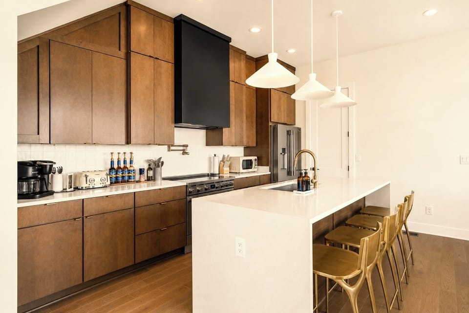 Bright modern kitchen with large island seating and sleek finishes.