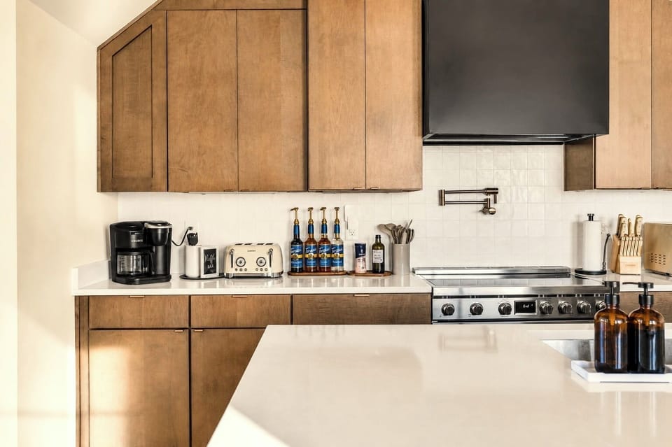 Bright modern kitchen with large island and premium cooking essentials.