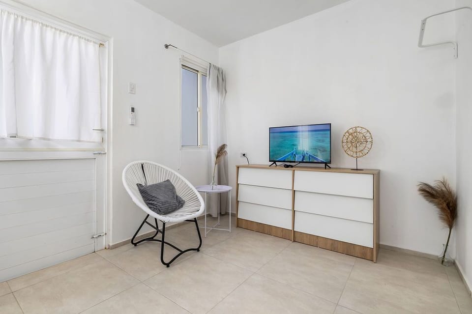 A flat-screen TV is positioned for optimal viewing, making it easy to enjoy your favorite programs without leaving the comfort of your bed.