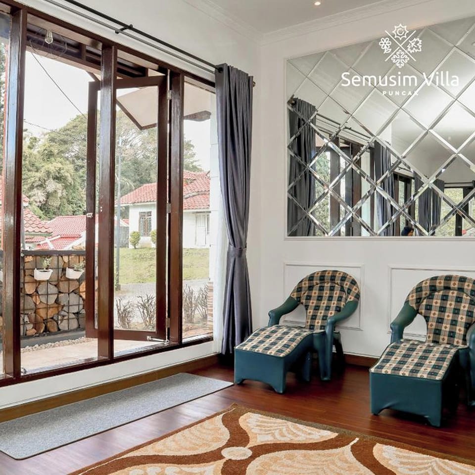 Villa | Living area | 32-inch LCD TV with cable channels