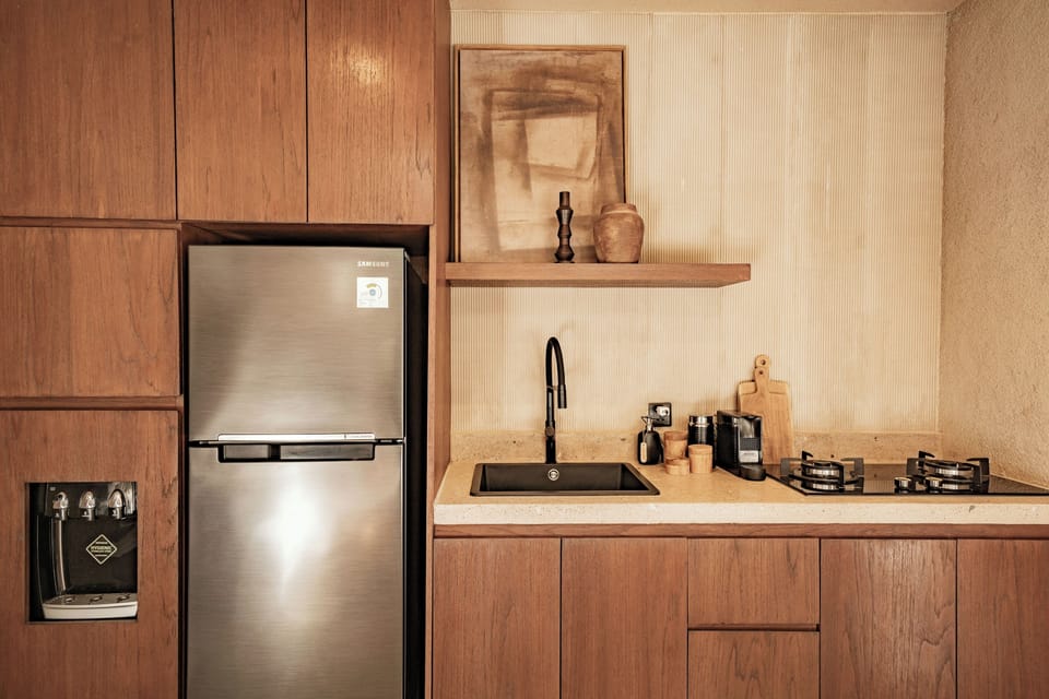 Junior Villa, Patio, Pool View | Private kitchen | Coffee/tea maker, cleaning supplies, freezer, dining tables