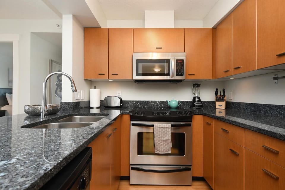 Gourmet kitchen setup complete with a full range, built-in dishwasher, and ample cabinet storage.