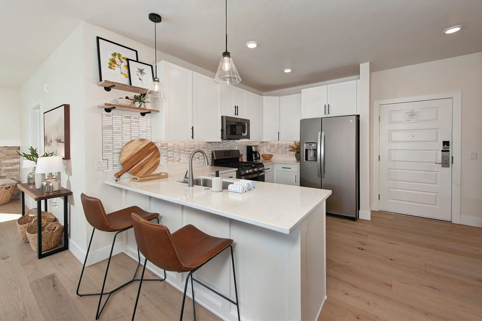 Full kitchen with recently updated, stainless steel appliances and small bar with seating for 2 people.