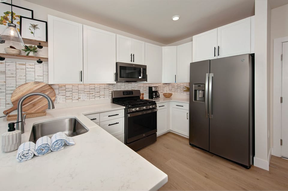 Full kitchen with recently updated, stainless steel appliances and small bar with seating for 2 people.