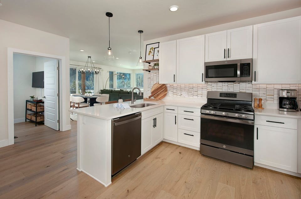 Full kitchen with recently updated, stainless steel appliances and small bar with seating for 2 people.