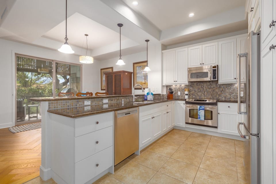 Kitchen has a refrigerator, dishwasher, stove and microwave.