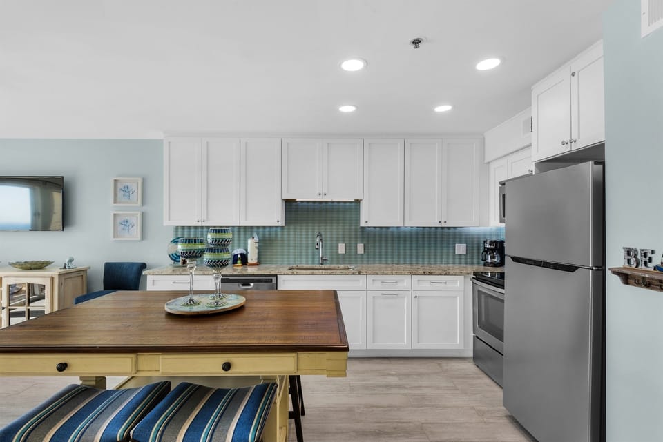 Your spacious kitchen invites culinary adventures with gleaming counters, modern appliances, and coastal charm throughout.