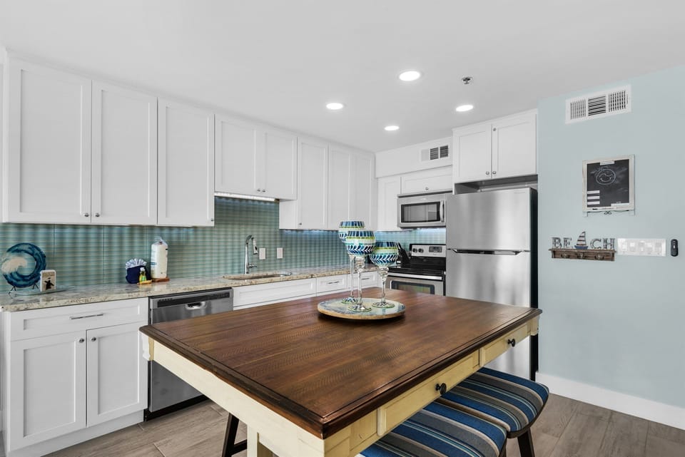 Step into your spacious kitchen where coastal charm meets modern convenience. You'll love preparing meals with stainless steel appliances and granite counters.