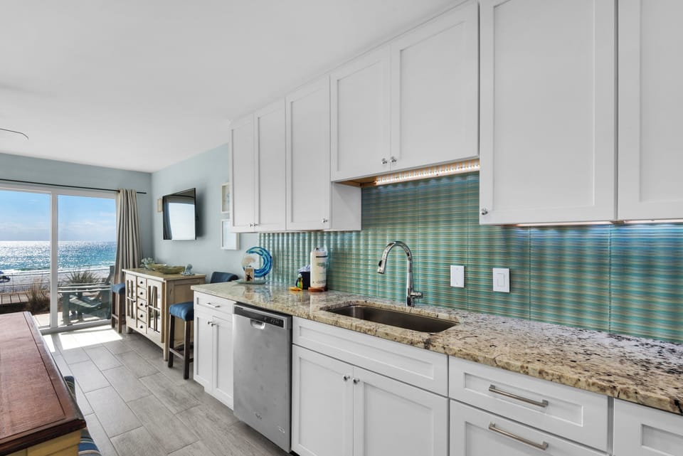 Your fully equipped kitchen features stunning ocean views, perfect for preparing meals while watching waves sparkle in the sunlight.