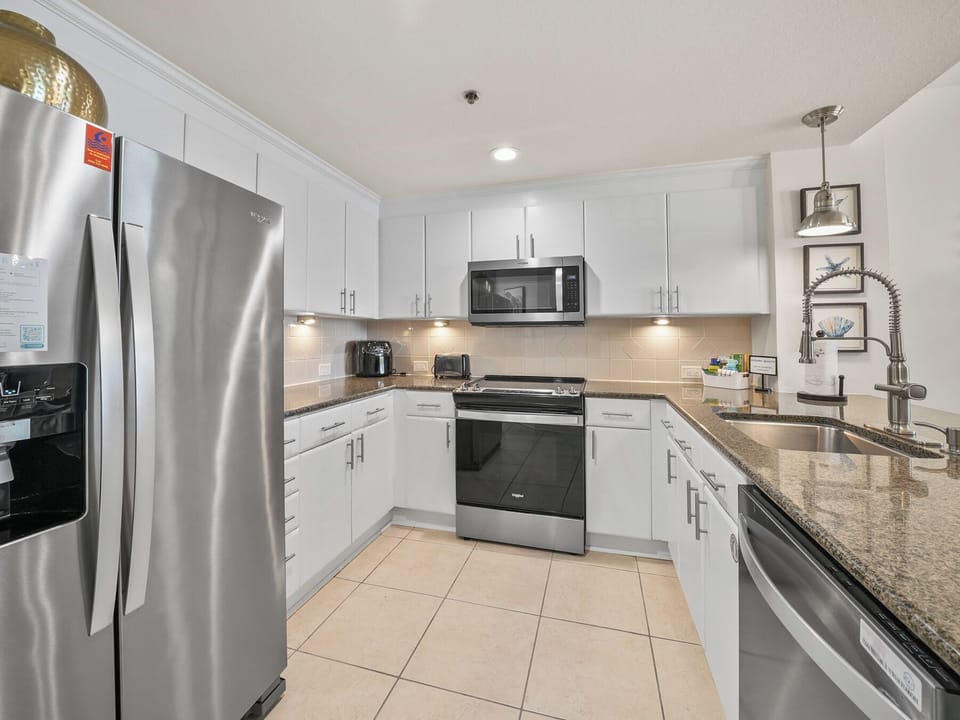 Your modern kitchen features granite counters, stainless appliances, and sleek white cabinets for all your culinary adventures.
