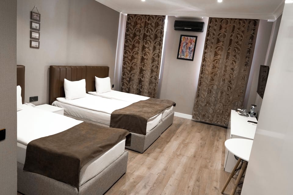 Comfort Triple Room, City View | Free minibar items, in-room safe, desk, laptop workspace