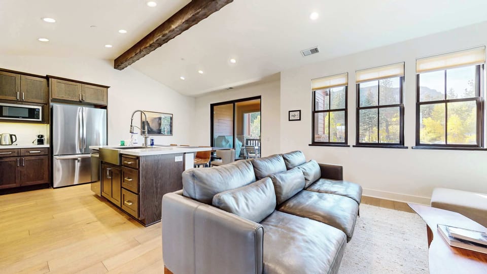 Bright living space with cozy seating and Smart TV