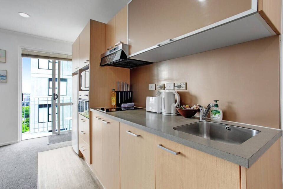 The kitchen has a cooktop, oven, microwave, dishwasher and fridge/freezer.