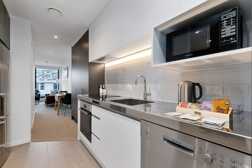 The kitchen has a cooktop, oven, microwave, dishwasher and fridge/freezer.
