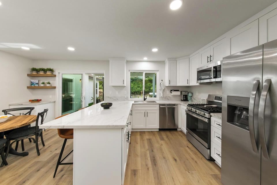 Kitchen includes: French door refrigerator, Stove, Microwave, Dishwasher, Blender, Griller, Mixer, T