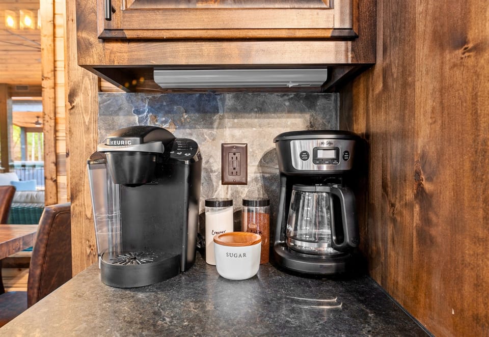Start your day with a fresh brew from this cozy coffee nook, thoughtfully stocked for all your caffeine needs.
