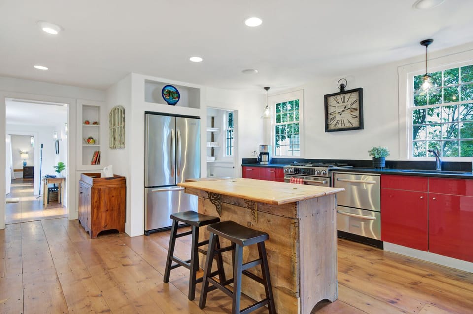 Gourmet Kitchen with Rustic Island and Red Cabinets