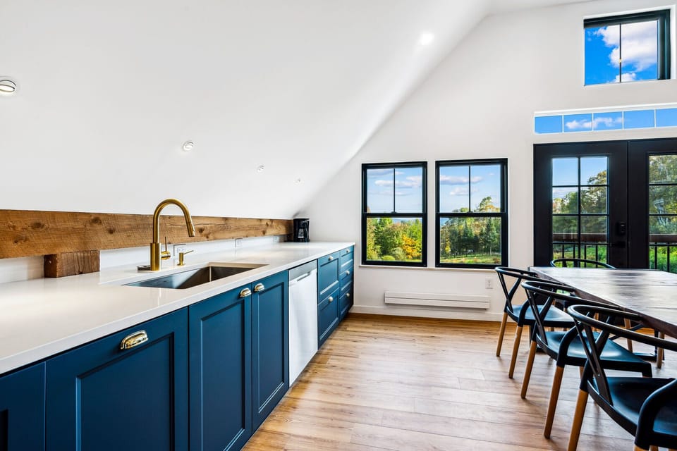 Chef's kitchen with quartz counters and a dining area overlooking the valley