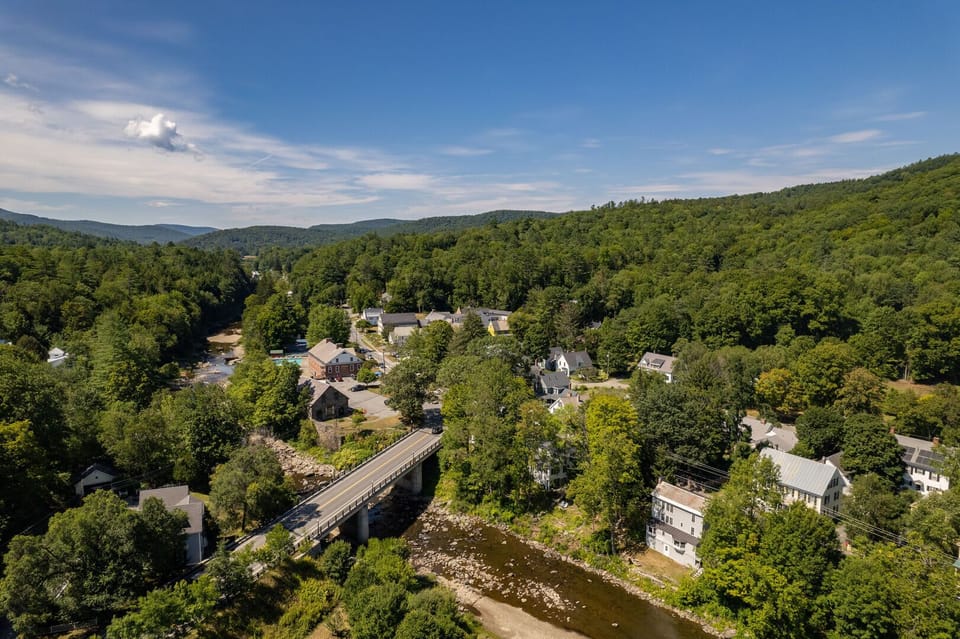 Aerial summer view of Woodstock Village with the covered bridge and Green Mountains
