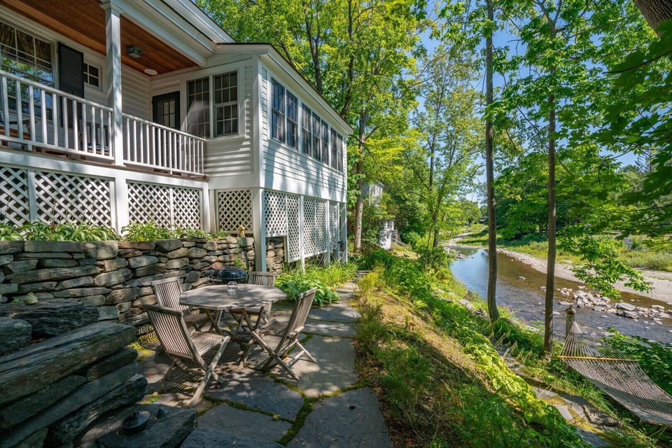 Al fresco dining on the stone patio alongside the river