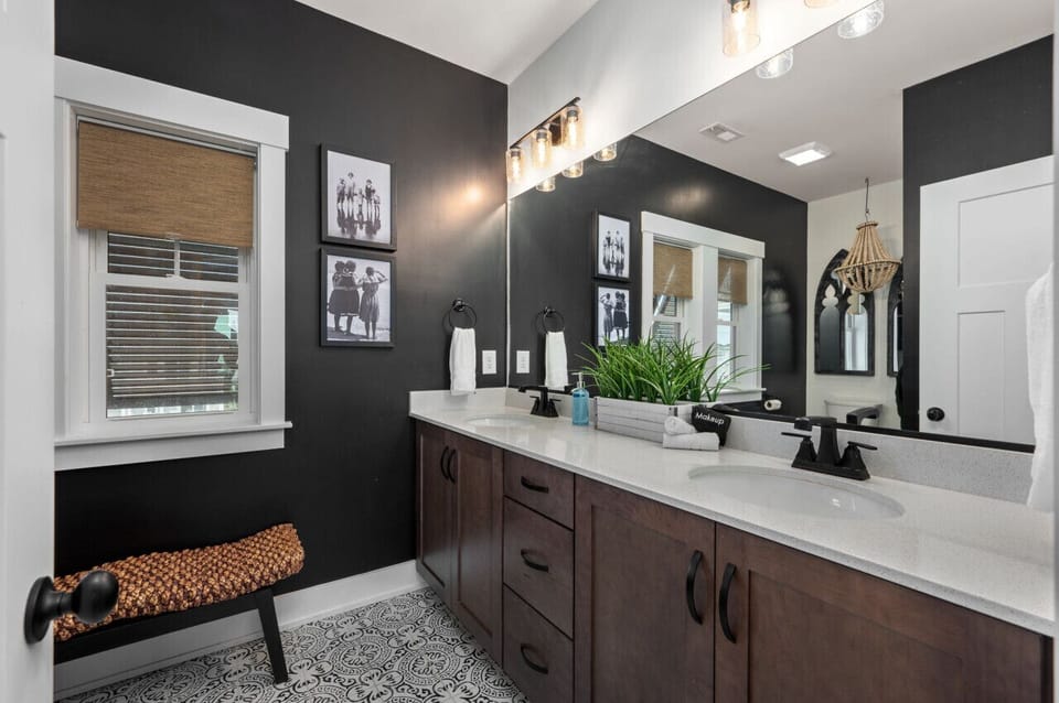 Stylish bathroom vanity w/ dual mirrors, bold contrast & thoughtful lighting.
