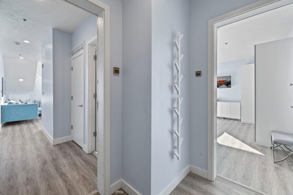Hallway with modern decor and wood floors.