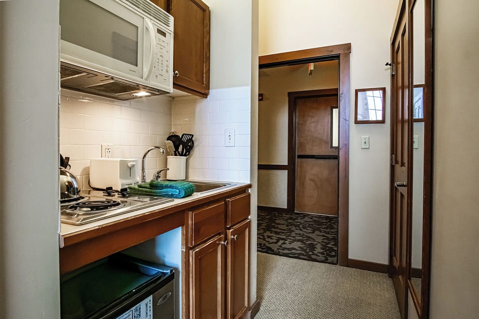 Kitchenette includes a mini fridge, cooktop and microwave.