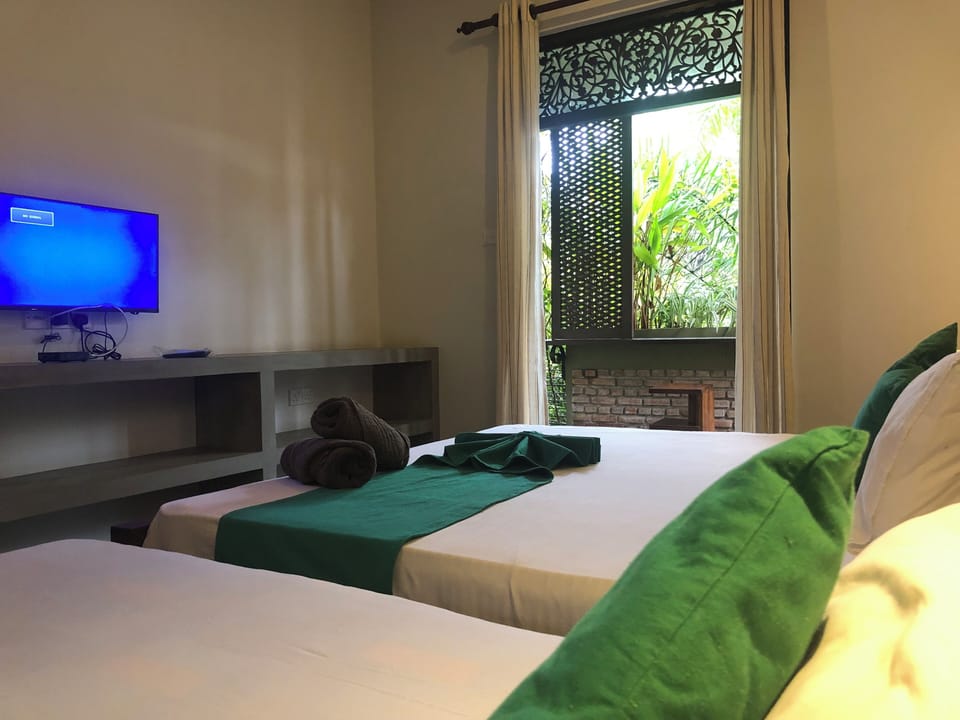 Deluxe Triple Room | Individually furnished, desk, laptop workspace, soundproofing