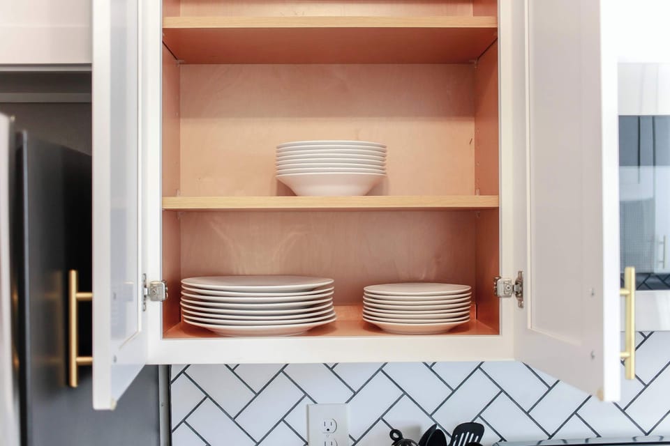 Plates in overhead cabinets.