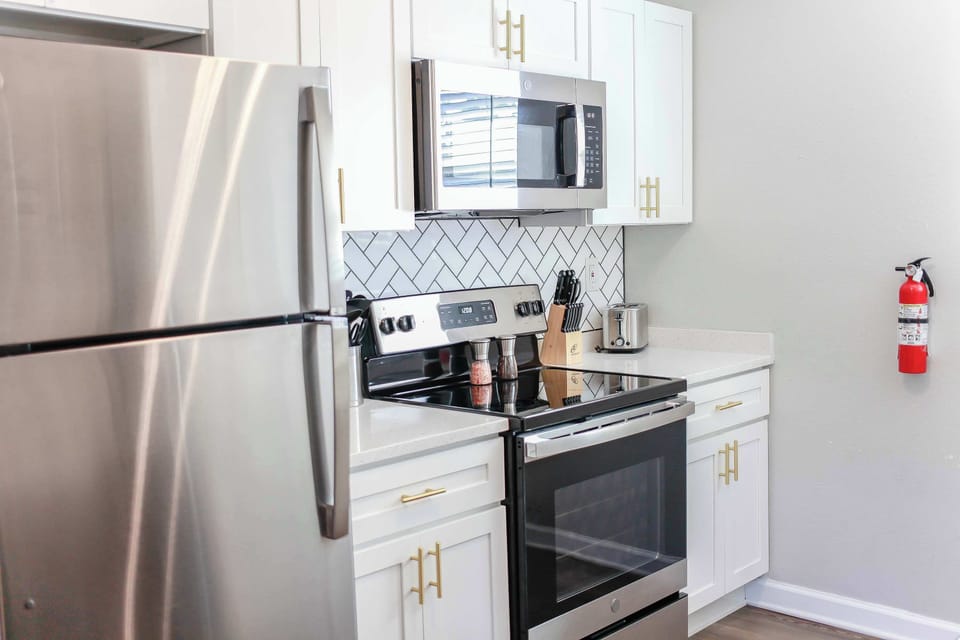 Full kitchen features stainless steel designed appliances.