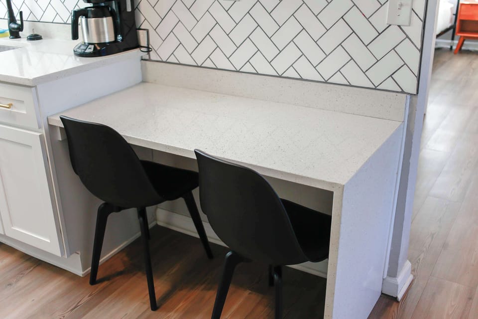 Kitchen counter with chairs.